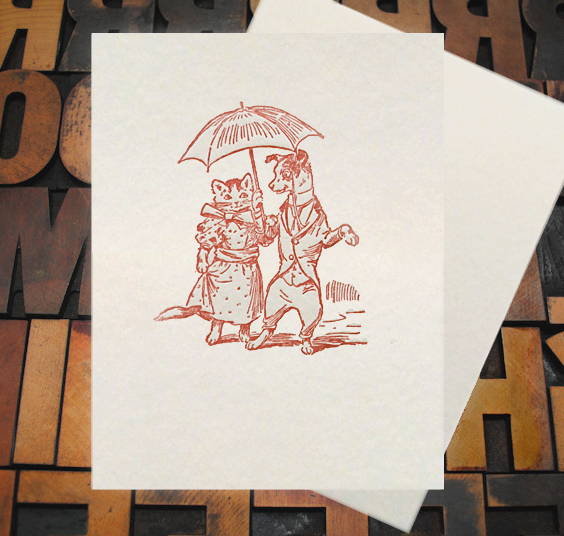 Letterpress Card with an image of a dog and a cat on a date, wearing clothes and carrying an umbrella